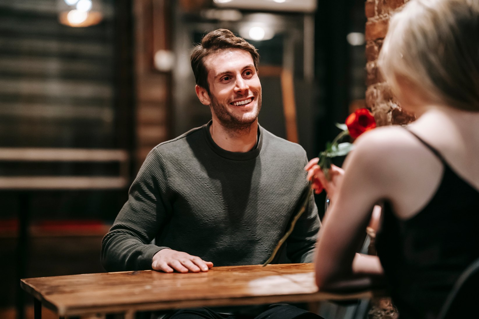 Happy couple sitting at table in cafe during date