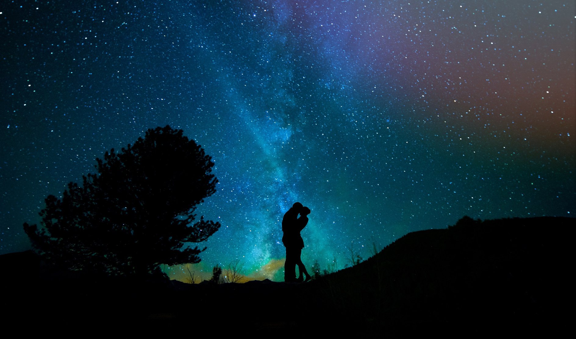 Couple Kissing under Starry Night Sky